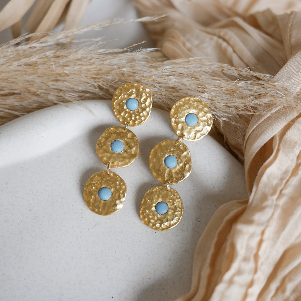 Boucles d’oreilles Byron en pâte polymère dorée, effet martelé, trois pièces articulées.